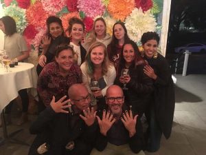 Artists with the flower wall.