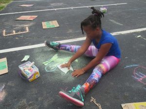 Shamrock Arts Festival girl drawing on sidewalk